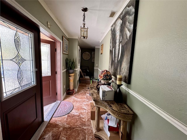 foyer entrance featuring crown molding