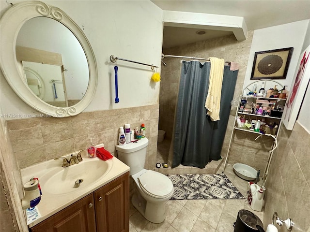 bathroom featuring tile walls, vanity, curtained shower, and toilet