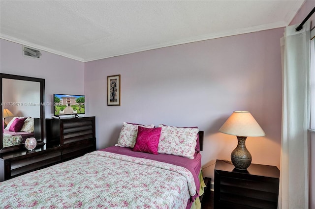 bedroom featuring ornamental molding and a textured ceiling