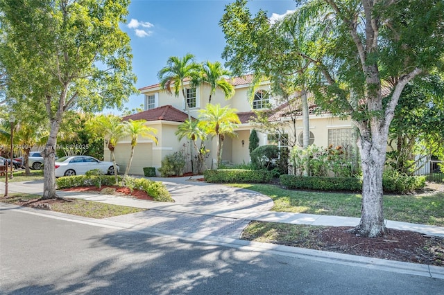 mediterranean / spanish-style home with a garage