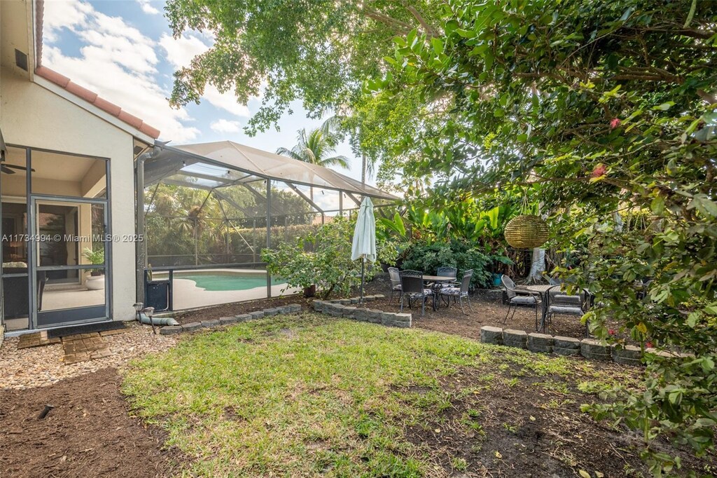 view of swimming pool featuring a lanai and a patio