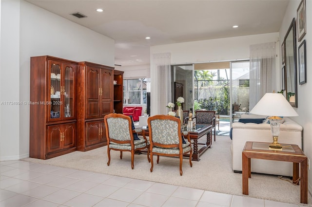 interior space with light tile patterned floors, recessed lighting, visible vents, and light carpet