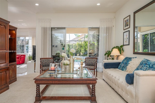 living area featuring recessed lighting and light colored carpet