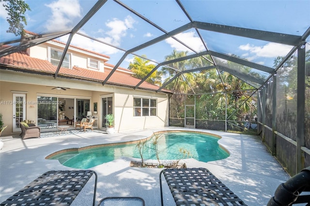 pool with a patio, a ceiling fan, and a lanai