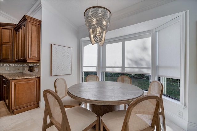 dining space with crown molding and a chandelier