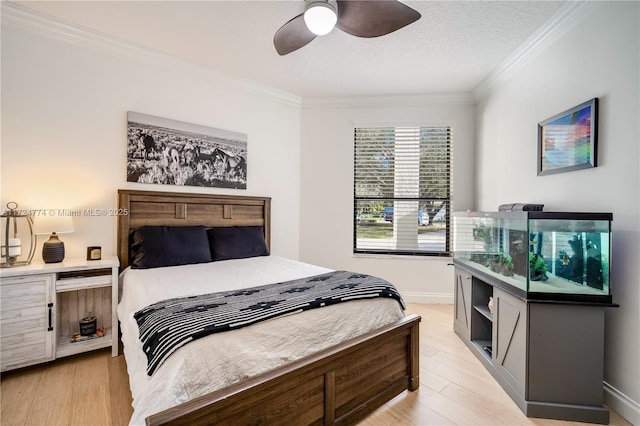 bedroom featuring crown molding, ceiling fan, a textured ceiling, and light hardwood / wood-style floors