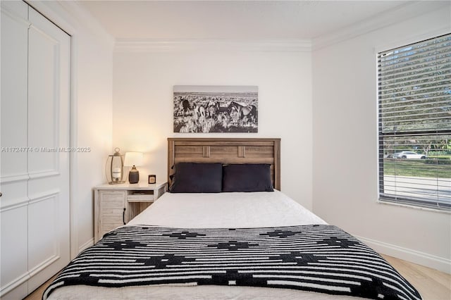 bedroom featuring crown molding and hardwood / wood-style floors