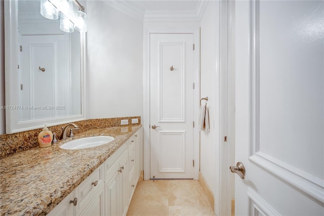 bathroom with crown molding, vanity, and tile patterned floors