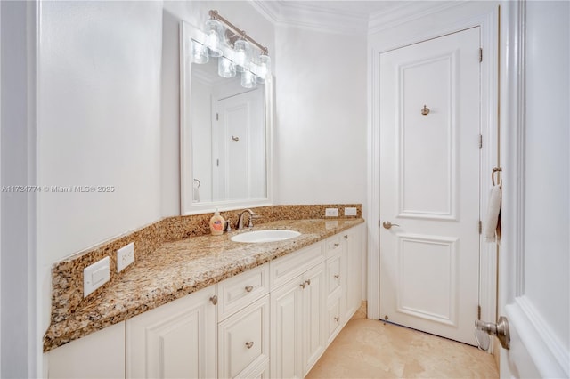 bathroom featuring ornamental molding and vanity