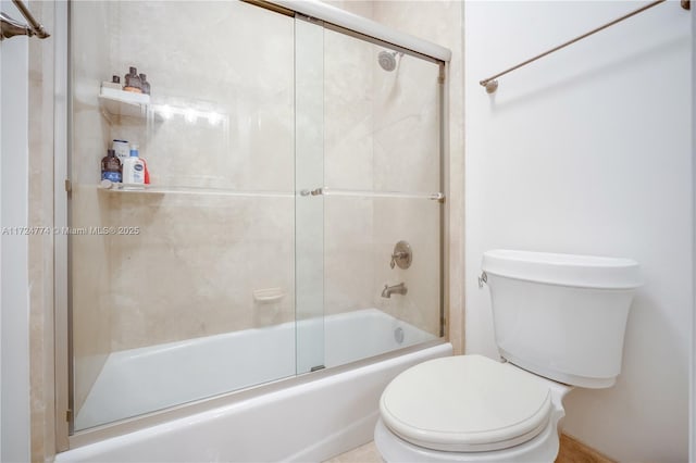 bathroom featuring toilet and combined bath / shower with glass door