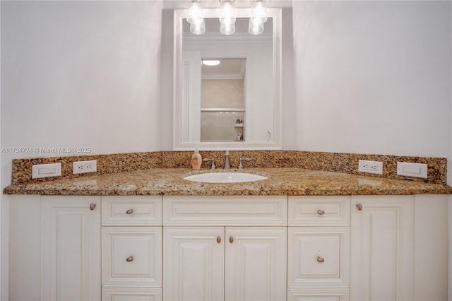 bathroom featuring ornamental molding and vanity