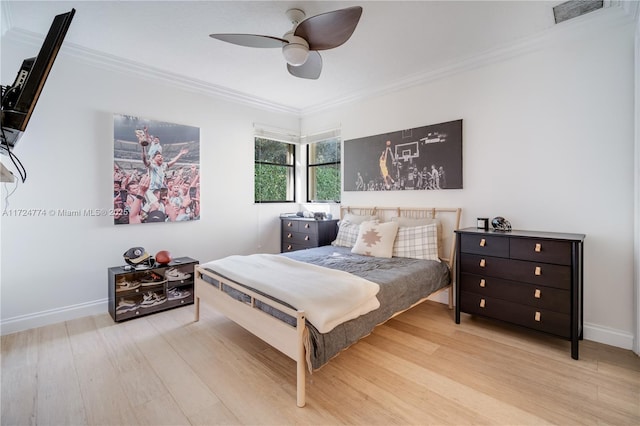 bedroom featuring ceiling fan, ornamental molding, and light hardwood / wood-style floors