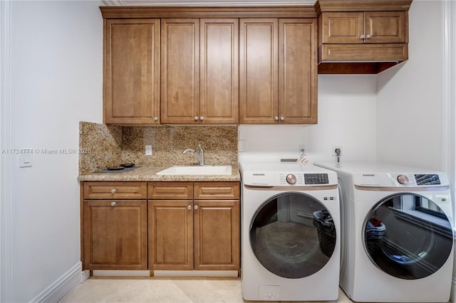 washroom with sink, cabinets, and independent washer and dryer