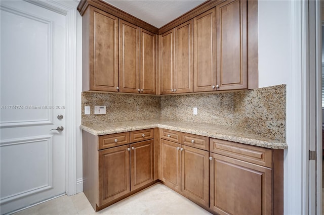 kitchen featuring light stone counters and decorative backsplash