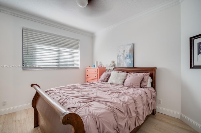 bedroom featuring crown molding and light wood-type flooring