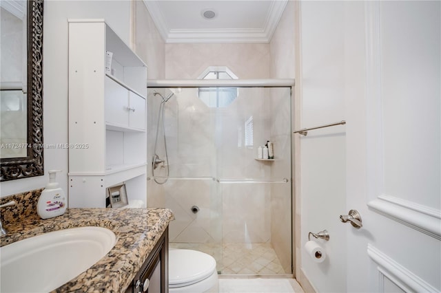 bathroom featuring vanity, a shower with door, ornamental molding, and toilet