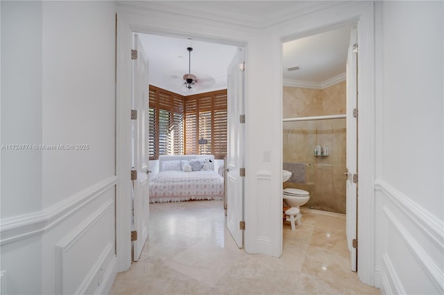 bathroom featuring a shower with door, ornamental molding, and toilet