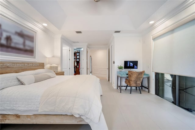 bedroom with crown molding, a walk in closet, and a raised ceiling