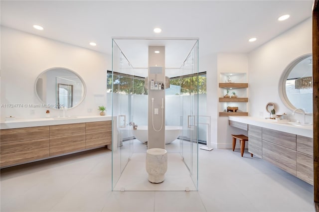 bathroom with tile patterned floors, vanity, and a bathtub