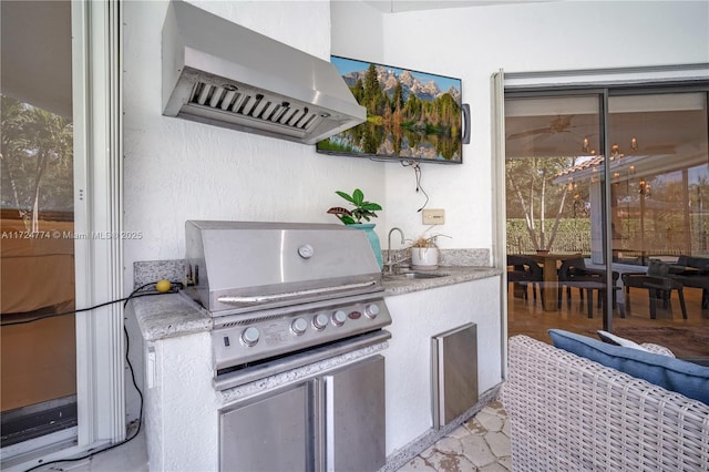 view of patio with an outdoor kitchen, sink, and area for grilling