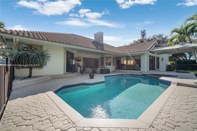 view of pool with cooling unit and a patio