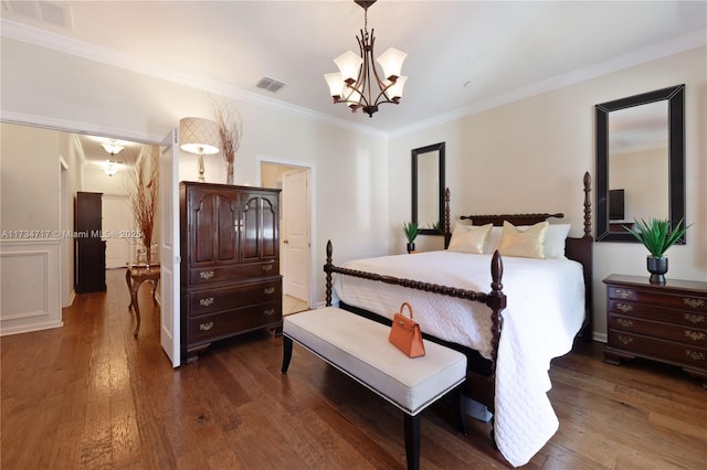 bedroom featuring an inviting chandelier, ornamental molding, and dark hardwood / wood-style floors