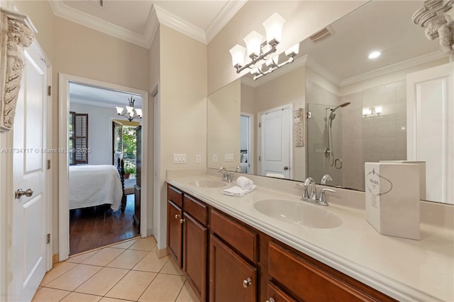 bathroom featuring crown molding, an inviting chandelier, vanity, tile patterned floors, and walk in shower