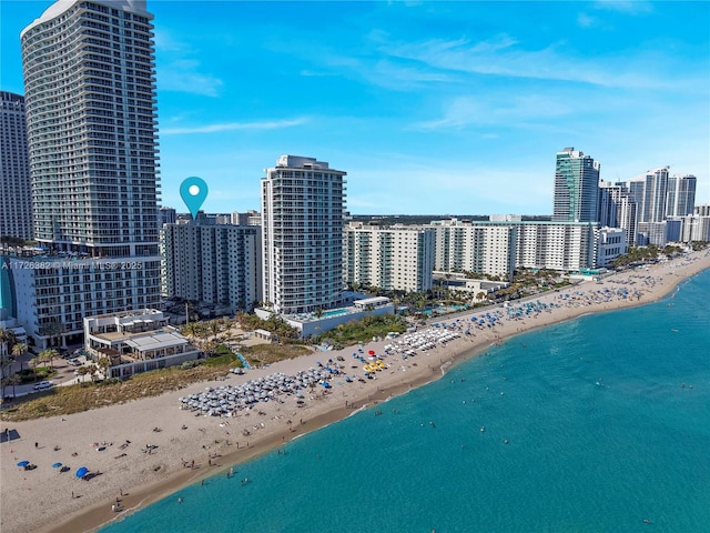 aerial view with a water view and a beach view