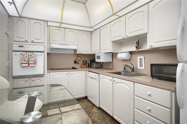 kitchen with white cabinetry, sink, and white appliances