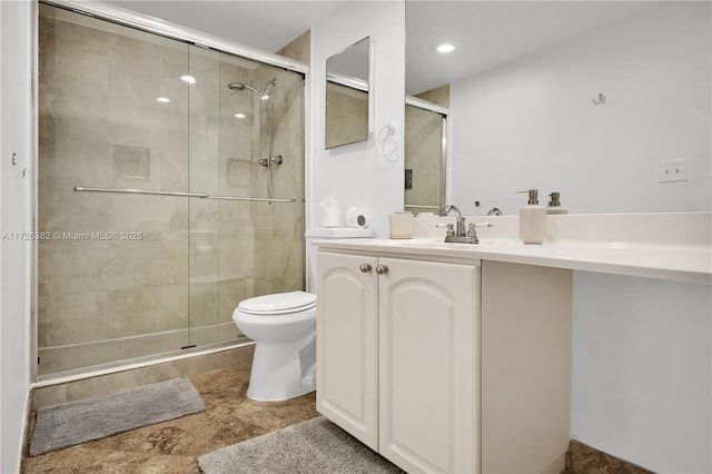 bathroom featuring vanity, walk in shower, and toilet