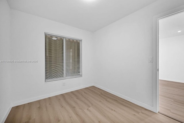 spare room featuring light hardwood / wood-style floors