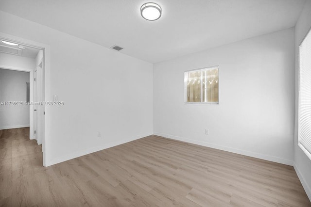 empty room with light hardwood / wood-style flooring