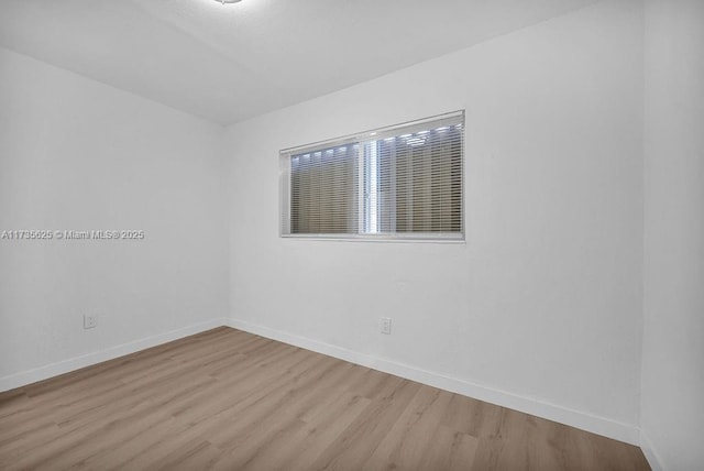 unfurnished room with light wood-type flooring