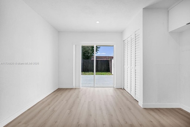 unfurnished room with light wood-type flooring