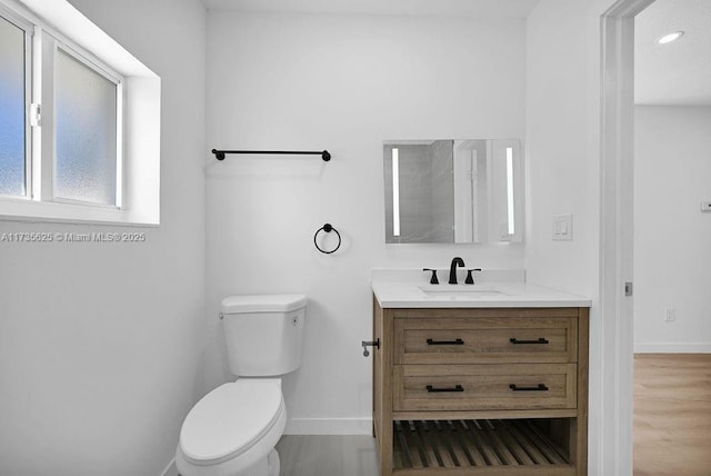 bathroom featuring vanity, toilet, and wood-type flooring