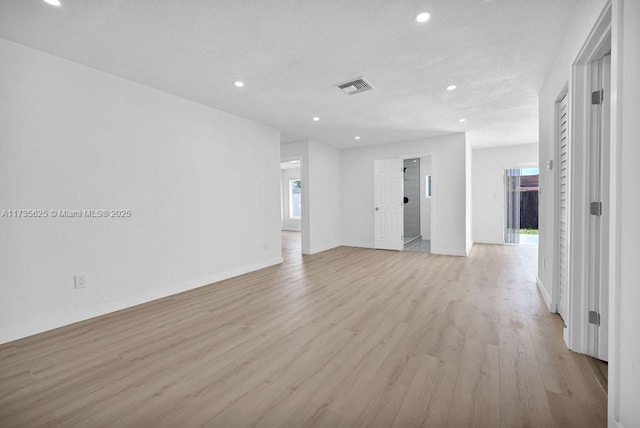 spare room with light hardwood / wood-style floors