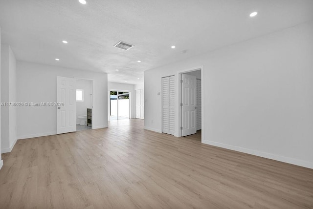 unfurnished room with light hardwood / wood-style floors