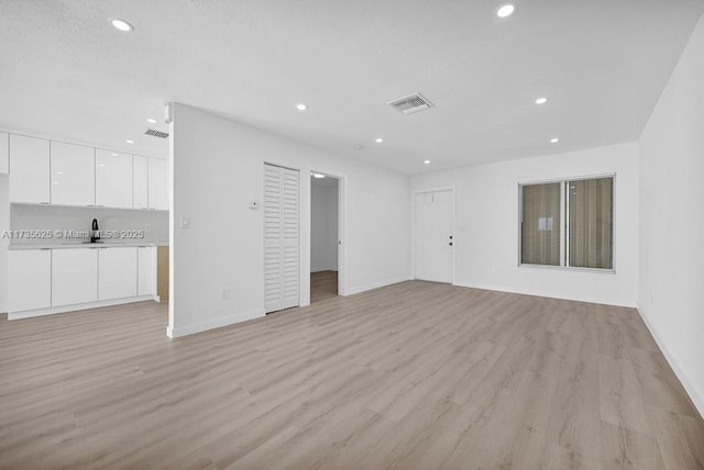 unfurnished living room with light wood-type flooring