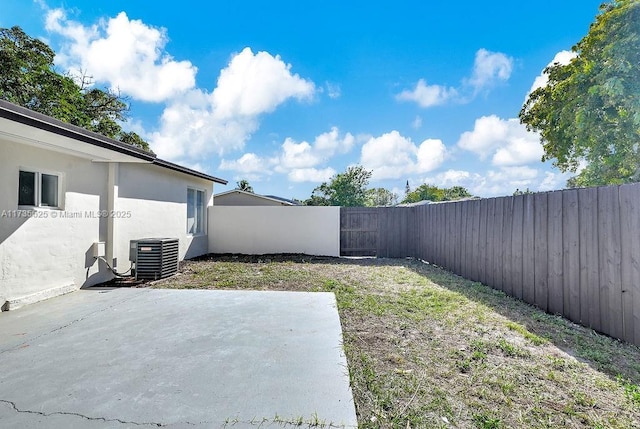 view of yard with a patio and central AC unit