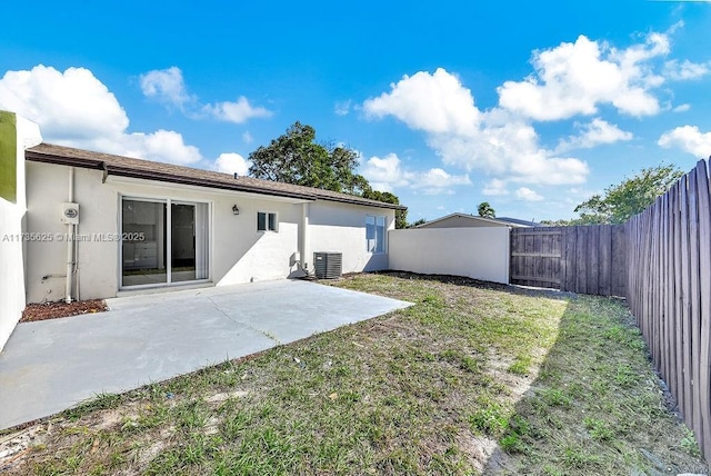 back of house featuring a patio, a lawn, and central air condition unit