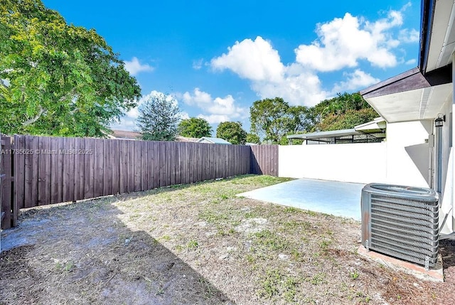 view of yard featuring cooling unit and a patio