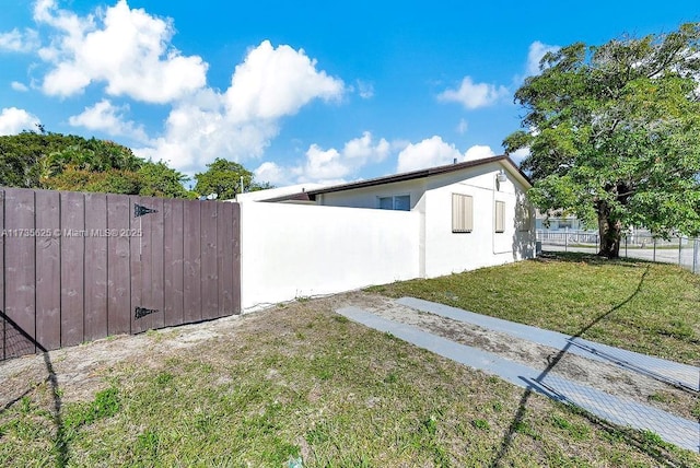 view of side of home featuring a yard