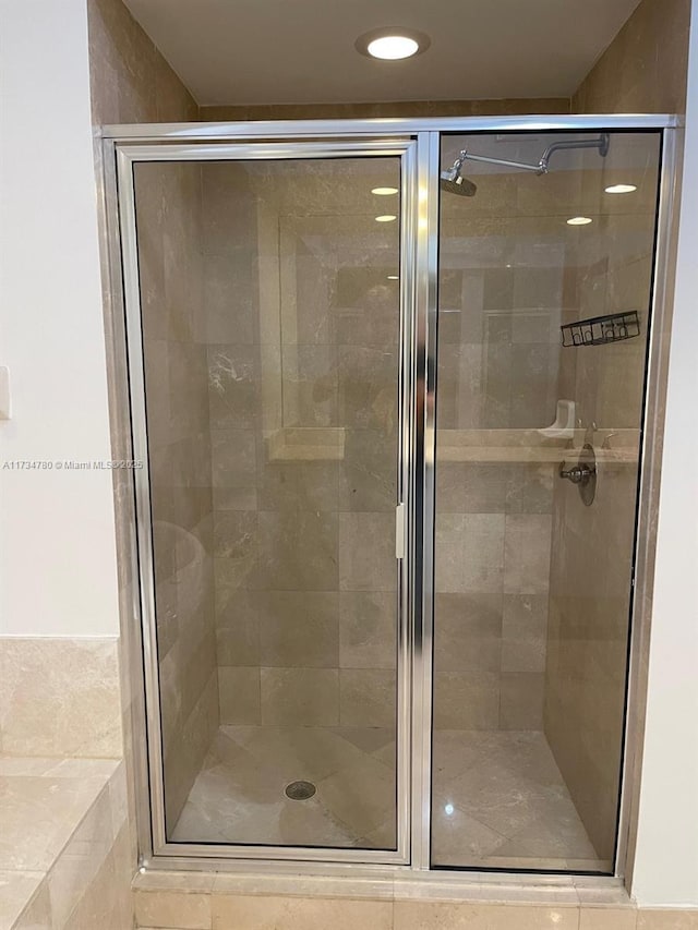 bathroom with a shower with door