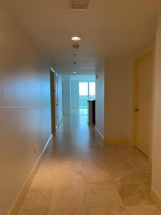 hallway featuring light tile patterned floors