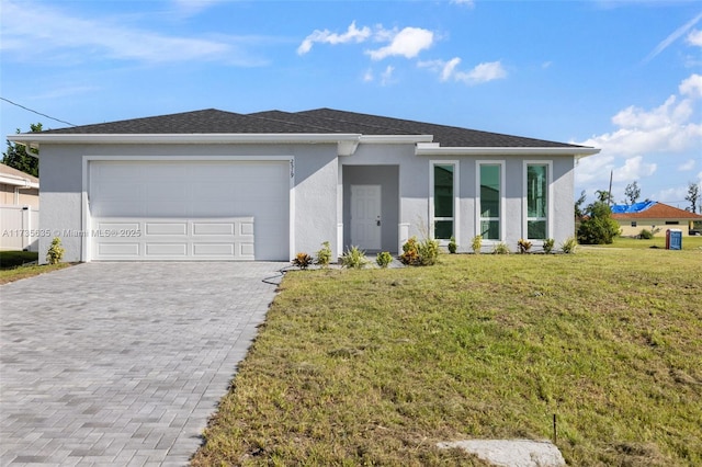 view of front of home with a garage and a front lawn