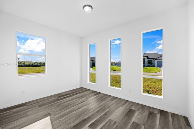 unfurnished room with wood-type flooring