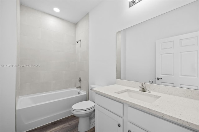 full bathroom with vanity, toilet, tiled shower / bath combo, and wood-type flooring