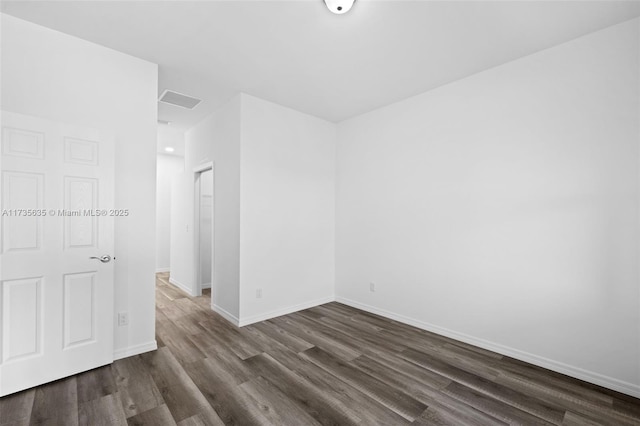 spare room with dark wood-type flooring