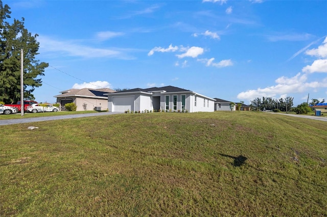 single story home featuring a garage and a front lawn