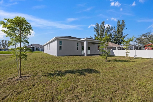 rear view of house with a yard